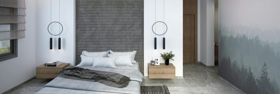 A bedroom with wallpaper, a grey headboard, and carpet