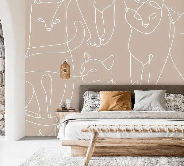 A bedroom with a cat themed wallpaper and a pendant light