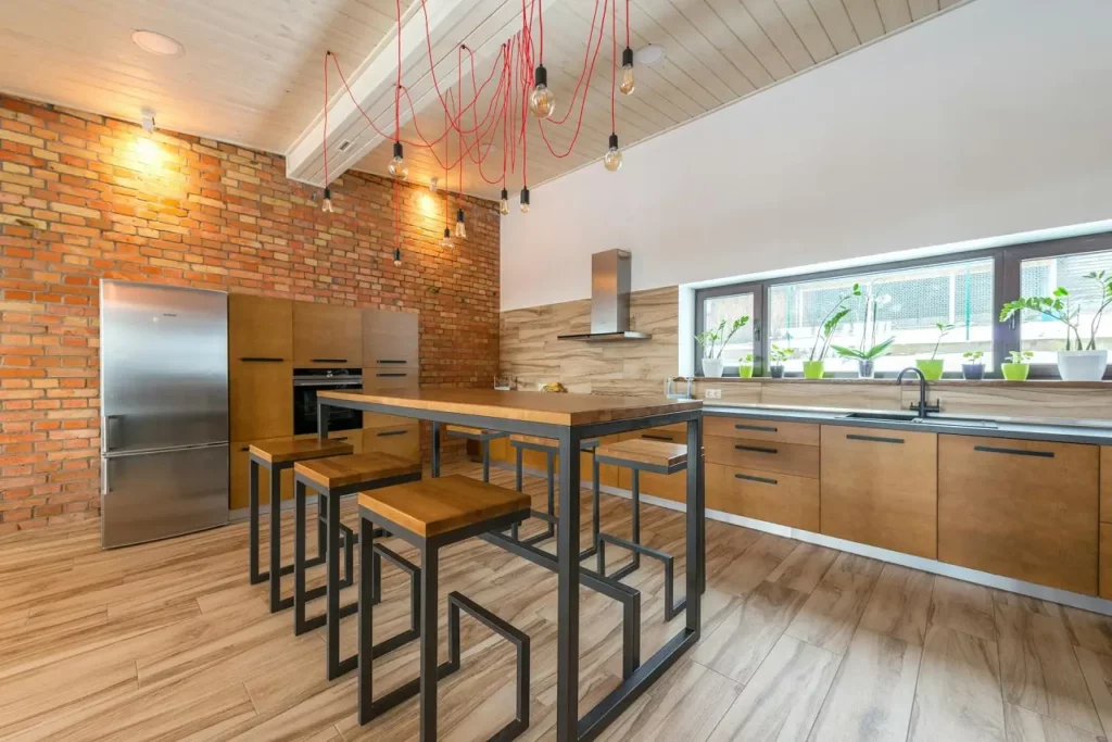 An industrial kitchen with metal bars and chairs