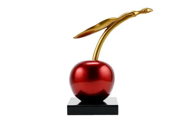 Cherry sculpture, red with gold stem, glossy finish on square base.