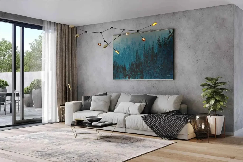 A living room area with a hanging lamp, gray couch and a large painting in color black and blue-green.