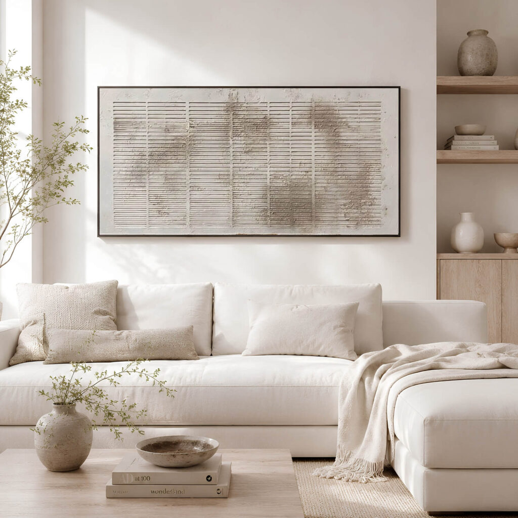 Modern living room with large textured abstract artwork above a cream sofa.